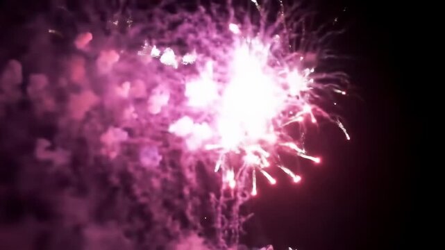 Exploding fireworks display in night sky, bright pink and white bursts, festive celebration, smoke trails, celebration, party