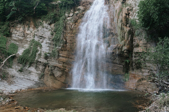 Majestic waterfall cascading into a rocky pool.