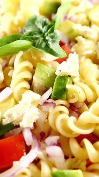 cold pasta salad with fusilli feta cheese tomatoes and basil