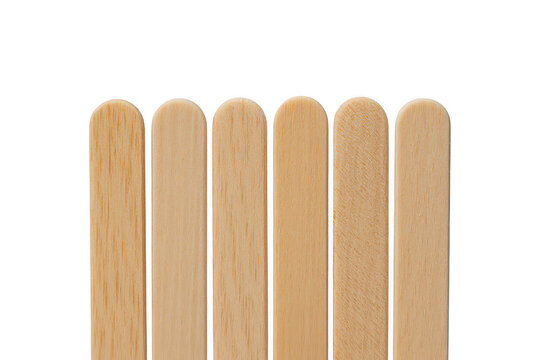 Six wooden popsicle sticks arranged in a neat row against a black background, showcasing the natural light brown texture of the craft wood