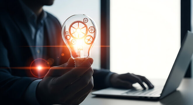 Glass lightbulb containing metallic gears illuminated with bright light representing innovation and problem solving bulb filament cogs mechanism