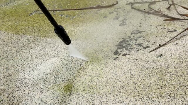High Pressure Water Blast Cleaning Algae From Dirty Swimming Pool Surface