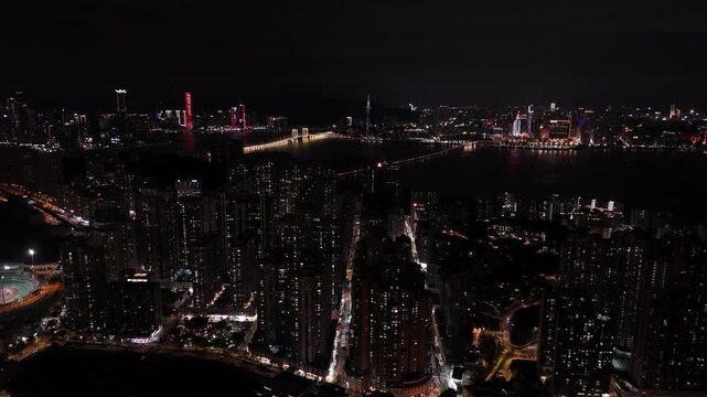Diving towards tall buildings in Macau at night
