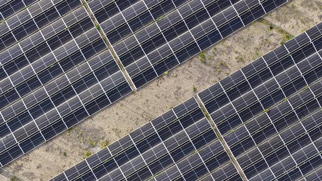 Endless rows of photovoltaic panels in a solar farm, converting sunlight into sustainable and clean electricity for a greener future, representing a key innovation in renewable energy technology