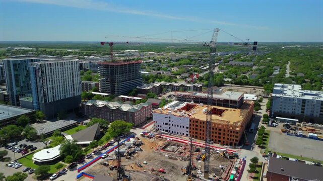 Drone flight around College Station Texas construction sites cranes and unfinished high rises
