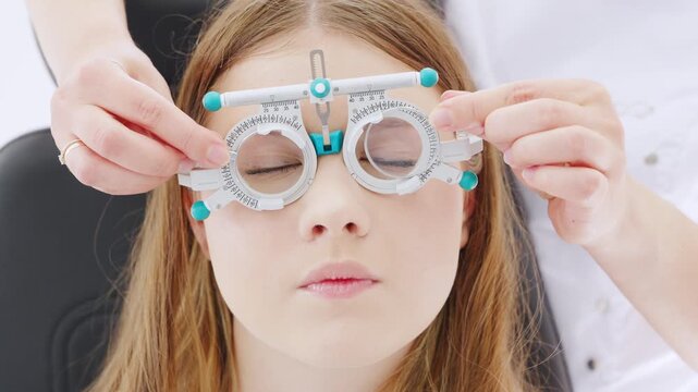 Optometrist performs vision test for patient