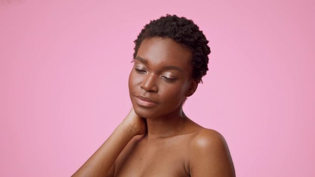 Calm Young Black Woman With Short Natural Hair Posing With Closed Eyes In Front Of Pink Background, Emulating Relaxation And Serenity. Beauty And Self-care Concept