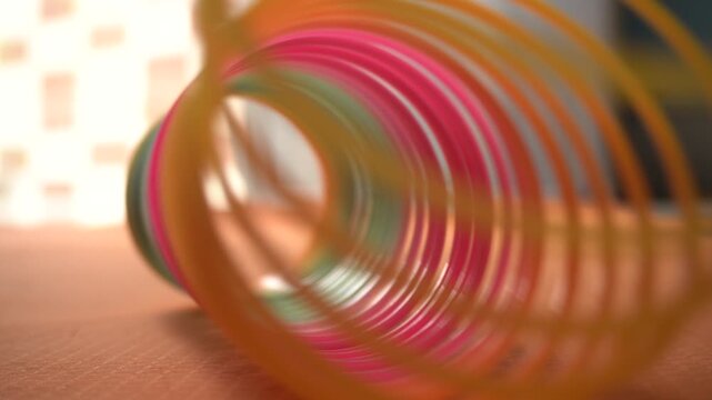 Colorful plastic rainbow magic spring toys, commonly known as slinkies, designed for fun playful movement and nostalgic entertainment.