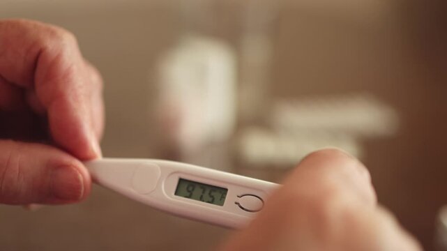 Thermometer. Thermometer. Hands. Body temperature. Slow motion video.. High quality 4k footage