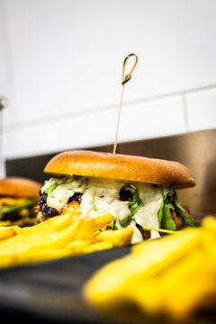 Gourmet burger with crisp fries close-up, premium fast food dining experience