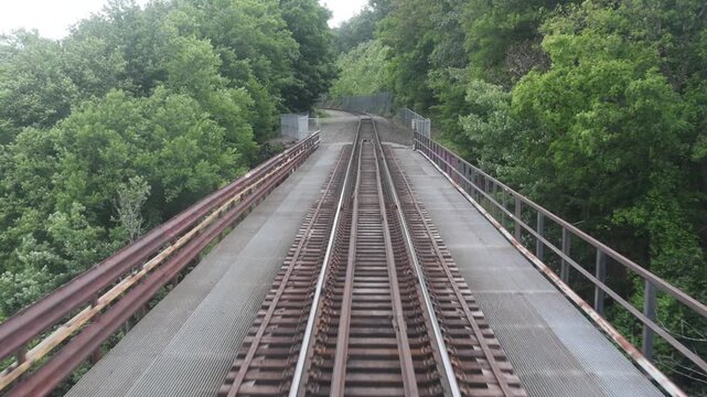 view from back of new jersey train from moodna viaduct of valley between mountains upstate new york (transit rail track railroad travel commute commuter line) port jervis new york