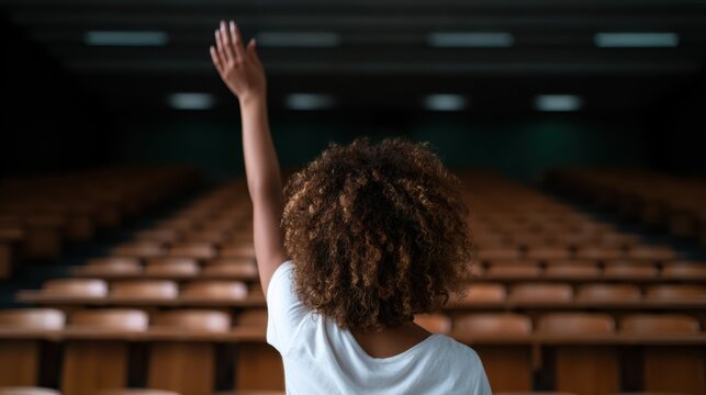 A lone figure raises a hand in an empty auditorium, capturing the essence of yearning for connection, knowledge, and the pursuit of ideas in an isolated setting.