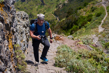 Fototapeta premium Hiker climbing rocky Anaga ridge trail