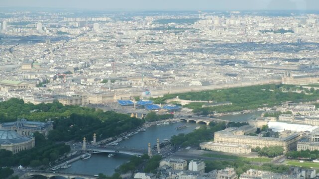 Expansive aerial view of paris cityscape with the seine river, pont alexandre iii, grand palais, and place de la concorde, revealing the city's famous landmarks