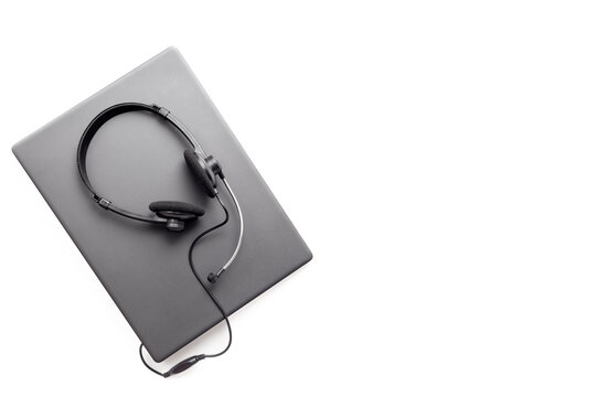 Modern call center desk setup with laptop and headset - online customer service and remote work concept