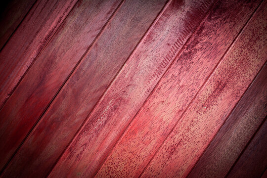 Red brown wooden plank texture background with vignette effect.