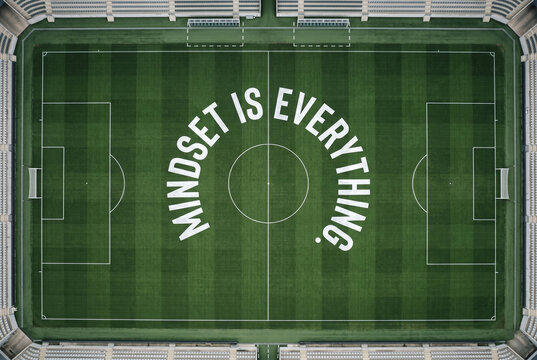 Aerial view of a soccer field with Mindset is Everything text