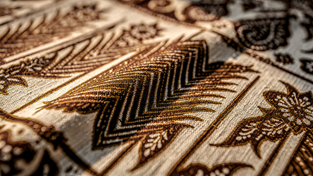 Indonesian batik fabric, traditional machete motif, hand-drawn diagonal blade design, dark brown soga and natural creamy white, visible cotton weave texture, cultural heritage fabric.
