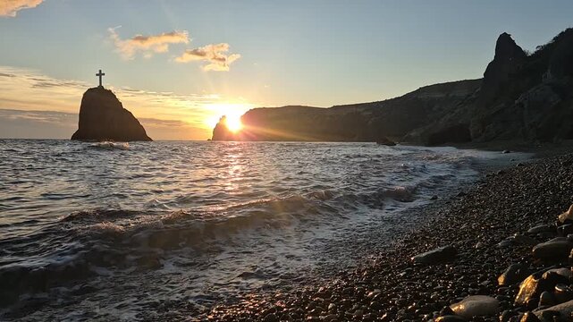 Sunset seascape cliffs waves crashing stony beach Saint George rock cross formation golden sky dramatic nature scene. Vertical video