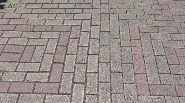 Walking through stone block paving road background 