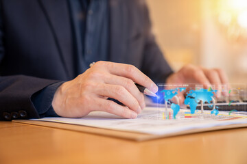 Naklejka premium Business professional analyzing documents with a digital global data interface overlay. Concept of business analytics, technology, finance and global communication.