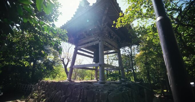 Ancient wooden Japanese structure on stone wall in Japan forest area - steady cam forward shot
