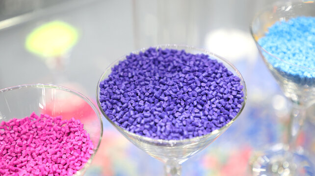 Purple plastic pellets or masterbatches stored in clear glass