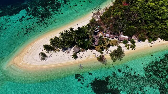 Breathtaking wide drone shot over Port Barton, Palawan, Philippines. Features a chain of lush green tropical islands surrounded by spectacular turquoise coral reefs and deep blue ocean waters.