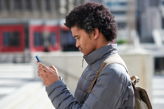 City, student and black man with phone for commute, digital navigation and university app for schedule. Serious, morning travel or person with mobile for directions, reading message or check location