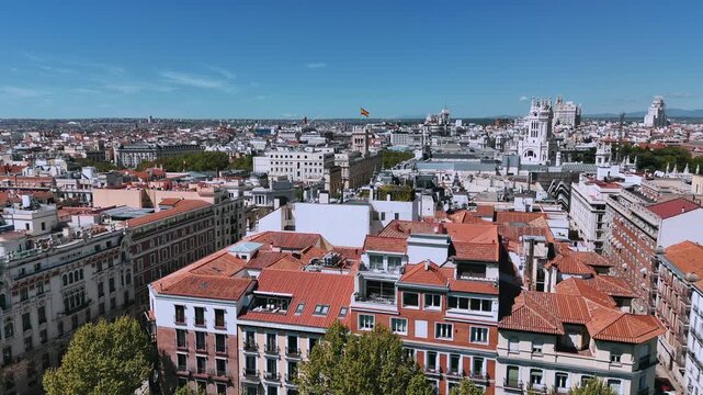 Aerial view over Madrid rooftops toward Cibeles and central skyline
