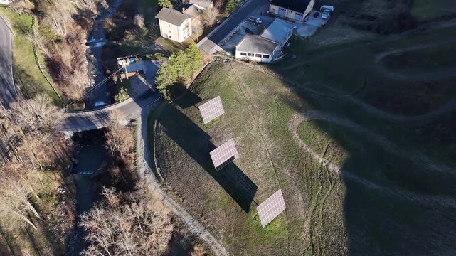 Drone aerial orbit over ground mounted photovoltaic micro installation in Morfasso Piacenza Emilia Romagna Italy showcasing renewable energy and sustainable technology concept
