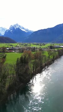 Linth Canal aerial view of Weesen, Switzerland historic town Glarus Alps, vertical video reel