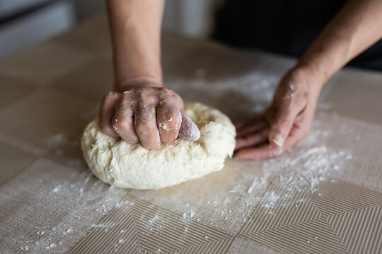 The housewife kneads and makes the scones in the traditional way according to an old recipe.