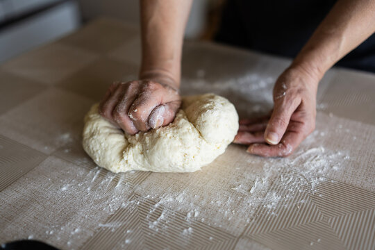 The housewife kneads and makes the scones in the traditional way according to an old recipe.