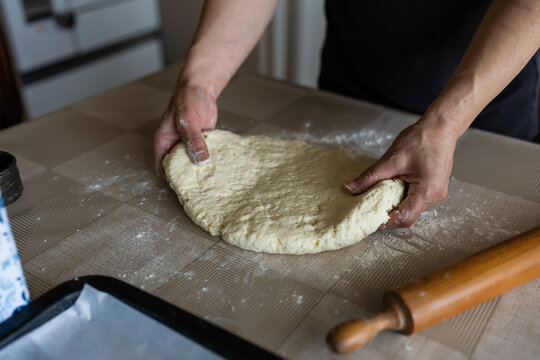 The housewife kneads and makes the scones in the traditional way according to an old recipe.