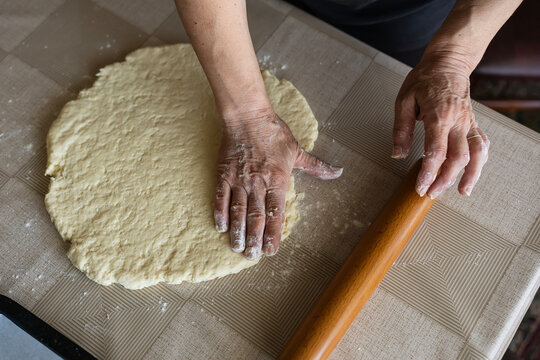The housewife kneads and makes the scones in the traditional way according to an old recipe.