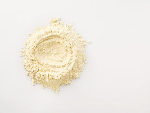 Flour pile on white background with a well in the center, baking and cooking concept for recipe development