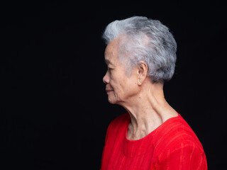 Senior Woman Profile Portrait on Dark Background © meeboonstudio