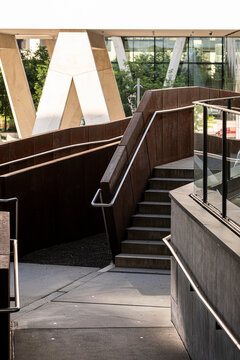 Angular stairs turn through architecture, where handrail, exterior, urban concrete, walkway, steps, design and geometry shape a modern route