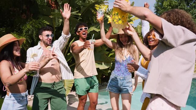 Diverse group of friends dancing at a summer pool party