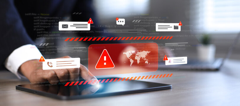 A close-up image of IT professionals or software developers analyzing source code and security warning icons on tablets and laptops illustrates the global cyber threat.