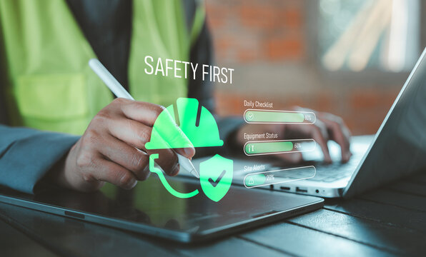 Zero accident and safety first concept industrial worker using tablet with holographic hard hat shield and compliance tracking progress bars