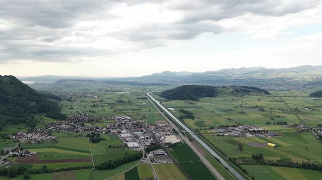 Linthebene Linth Plain canal in Switzerland aerial drone landscape field