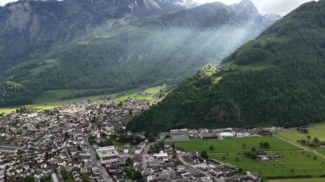 Mountain village base of Swiss Alps alpine region Glarus Alps Switzerland, aerial drone landscape