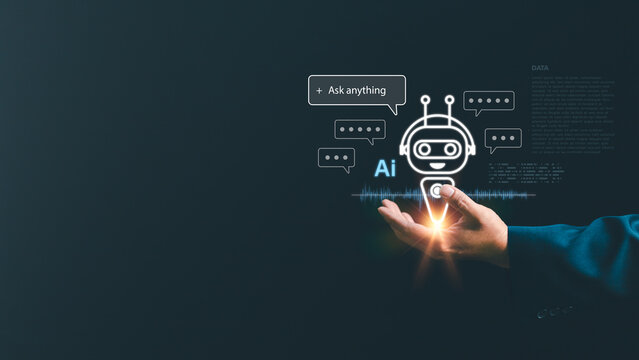 Businessman hand holding a glowing AI chatbot icon with virtual chat bubbles. Futuristic artificial intelligence, machine learning, and digital virtual assistant technology concept
