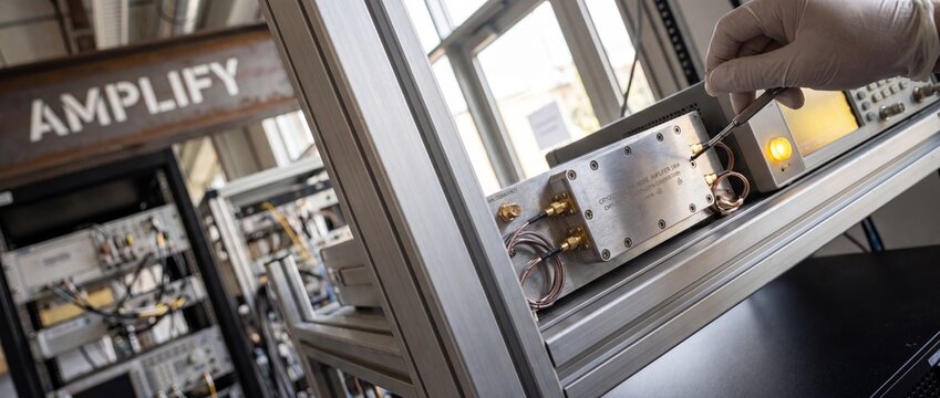 Cryogenic low noise amplifier testing in scientific engineering laboratory by technician adjusting high tech electronic hardware equipment for research development and advanced telecommunications work