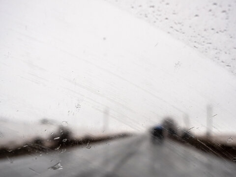 view of car's windshield being cleaned by wipers