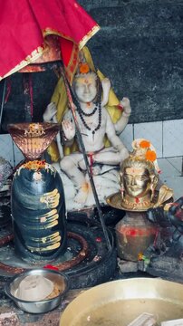 Devotional view of Lord Shiva with sacred Shiva Lingam decorated for worship inside a Hindu temple, capturing India's rich religious heritage and spiritual traditions.
