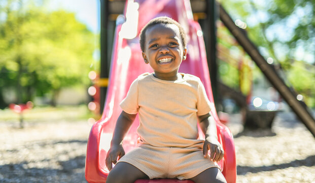 Happy young american child on playground this summer season