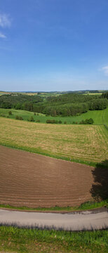 Rolling agricultural landscape with fields and forests in Thommen, Belgi&euml; - Haute Fagnes region panoramic countryside view